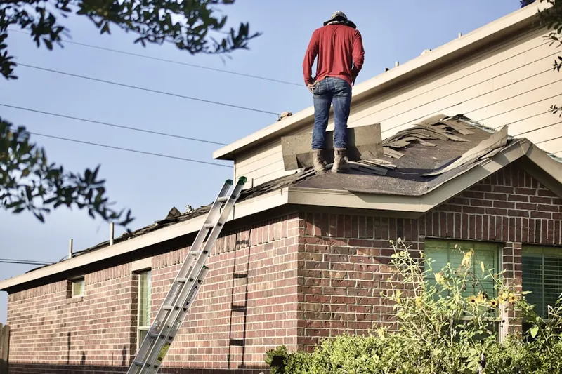 Professional roofer working on a residential roof in London Grove